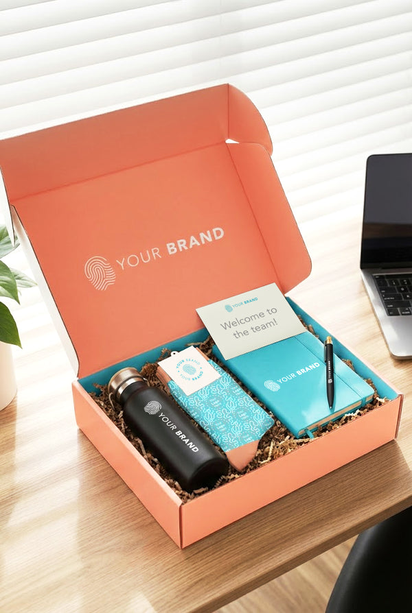 Open orange box with branded items on a desk
