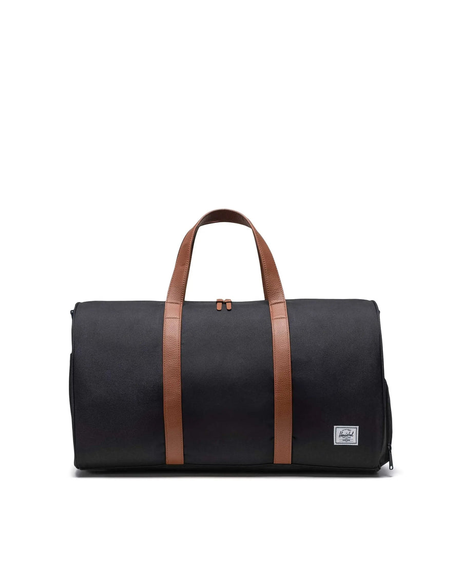 Black duffel bag with brown straps on a white background