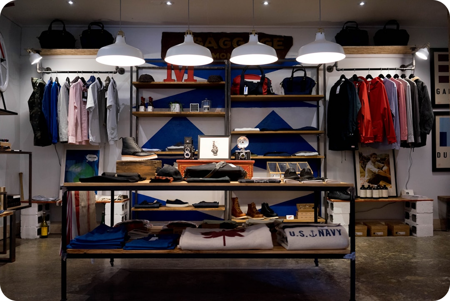 Clothing store interior with shelves displaying various items and clothing racks.