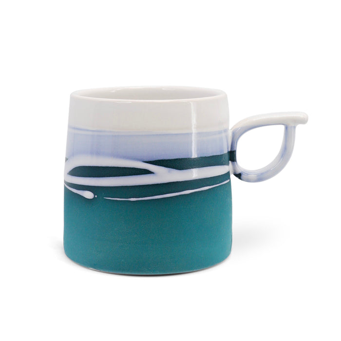 Handmade Paul Maloney ceramic mug with teal glaze